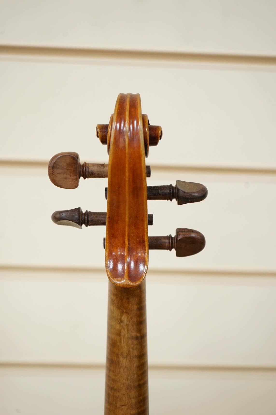 Three cased violins; a German Dresden violin, supplied by Campbell and co., Glasgow, together with another Dresden Stradivarius copy, and the remains of a European violin.